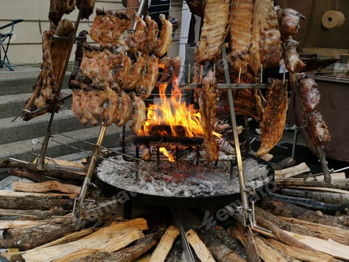 Preview: Asado, traditional barbecue in Argentinian grilled meat Cooked in a vertical oven placed around th