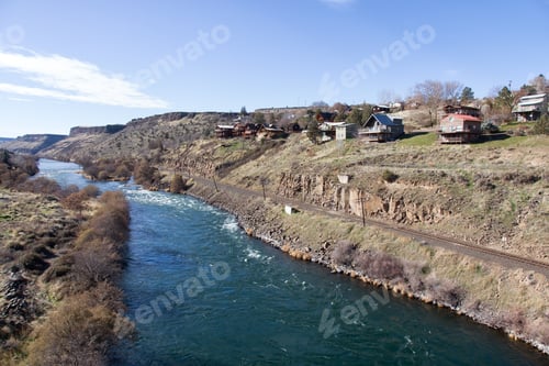Preview: View on the residential homes by the river during a vibrant sunny winter day
