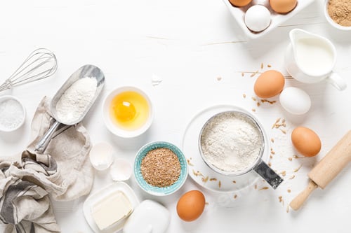 Preview: Baking homemade bread on white kitchen worktop with ingredients for cooking, culinary background