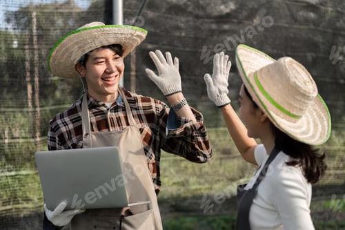 Preview: Modern Farmer Couple Cultivating Herbs and Cannabis in a Greenhouse Setting with Sustainable