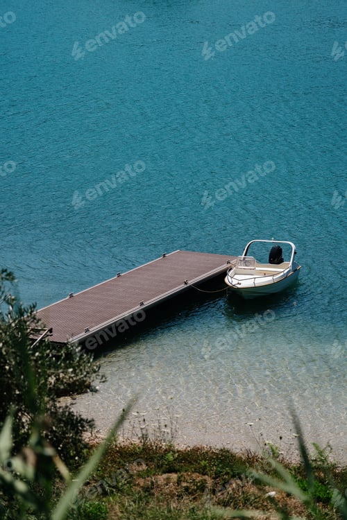Preview: Serene lake scene with a single boat at a dock