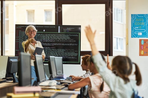 Preview: Senior Caucasian Woman Teaching Coding to Diverse Children in Computer Class