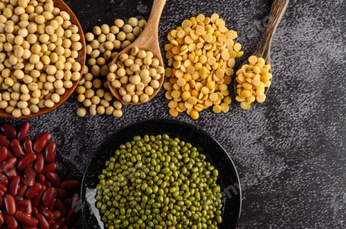 Preview: Legumes, and beans assortment on the black cement floor.