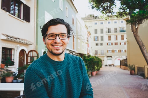 Preview: Smiling young man against a urban scene