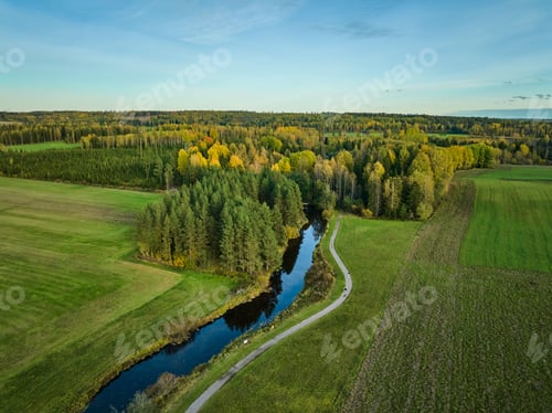 Preview: Aerial view of lush landscape with river and forest.