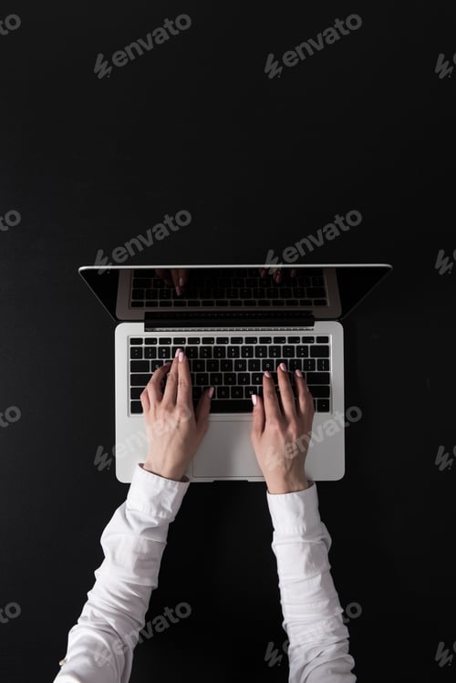 Preview: cropped shot of woman working on laptop isolated on black