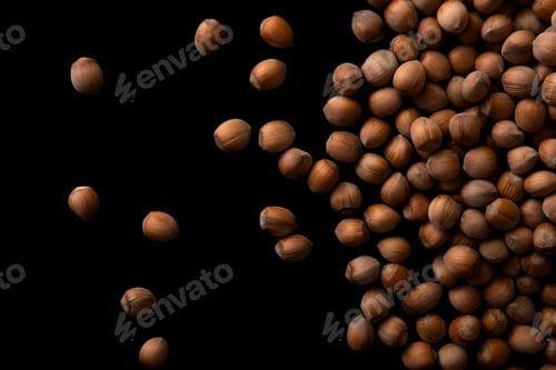 Preview: Hazelnuts food background, isolated on black, top view