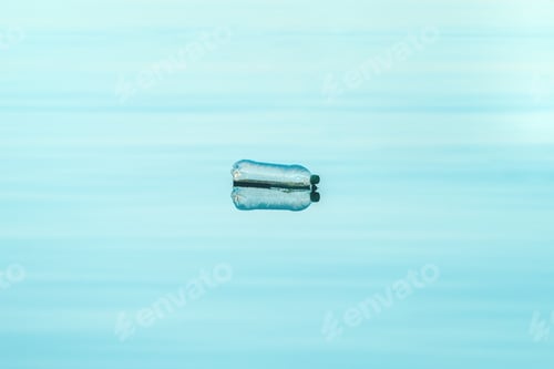 Preview: Empty plastic bottle floating on water, environmental damage and pollution concept
