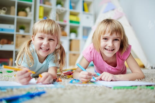 Happy Girls Drawing Pictures in Playroom
