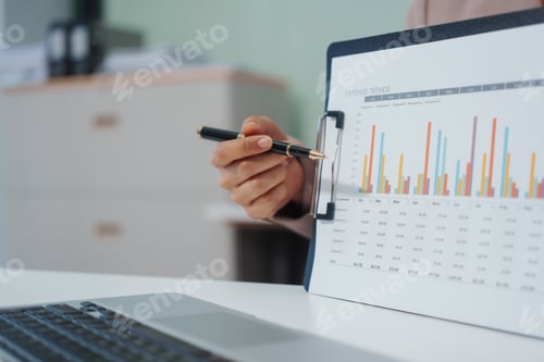 Preview: An Asian businesswoman accountant calculates invoices, taxes, interest, loans using a calculator