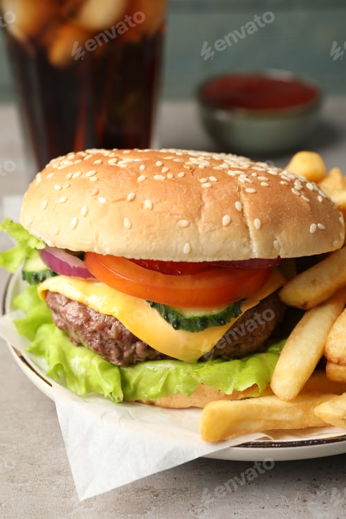 Preview: Delicious burger, soda drink and french fries served on grey table, closeup