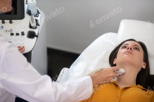 Preview: Female doctor making ultrasound thyroid gland test