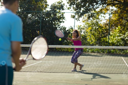 Preview: Image of diverse couple playing tennis