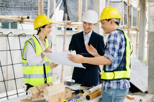 Preview: Engineer teams meeting working together wear worker helmets hardhat on construction site