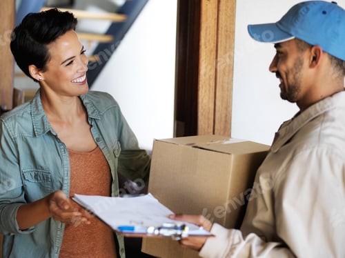 Preview: Shot of a smiling young woman standing at her front door receiving a package from a courier