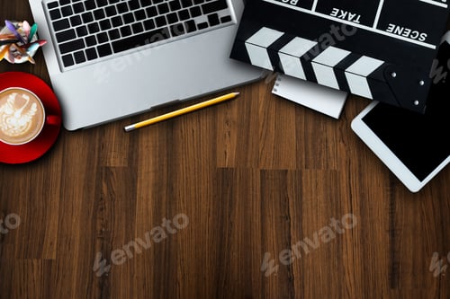 Preview: office stuff with Movie clapper, laptop, smartphone, tablet, coffee cup, pen, notepad and documents