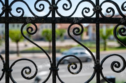Preview: Detail of a wrought iron fence on a street in the city. Selective focus.