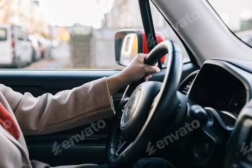 Preview: Unrecognizable person driving car in the city during the day