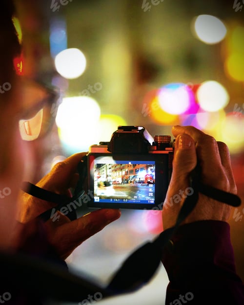 Preview: Vertical selective focus closeup of a camera with a photo of a mall