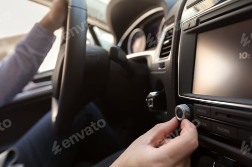 Preview: Hand Pushing the power button to turn on the car stereo system