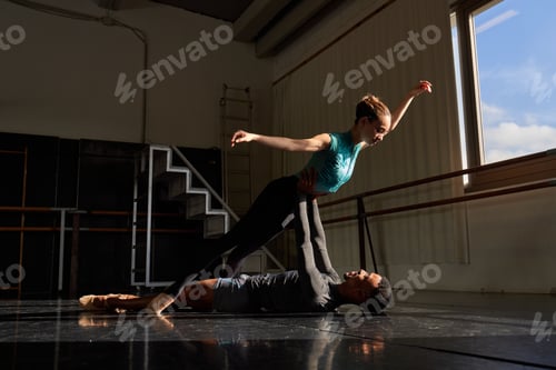 Preview: Couple of black boy and white girl in a class doing a training in ballet academy