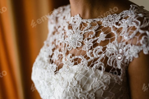Preview: Detail of a white and elegant wedding dress.