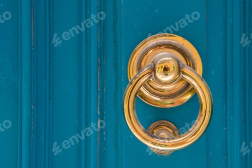 Preview: Golden door knocker on a blue wooden door. Mdina, Malta