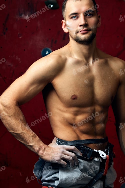 Preview: Closeup portrait of rock climber against artificial wall for climbing