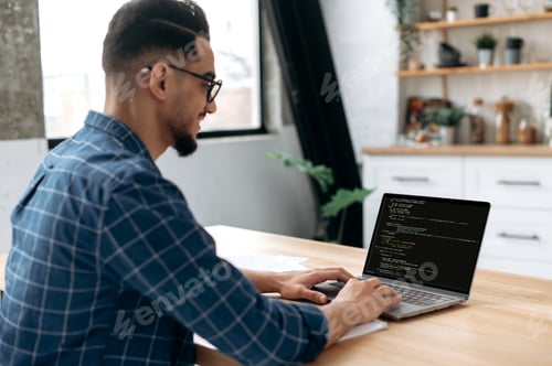 Preview: Side view of a programmer with laptop. Clever successful guy, an IT specialist, software developer