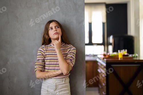 Preview: Young Girl Thinking near Kitchen Area
