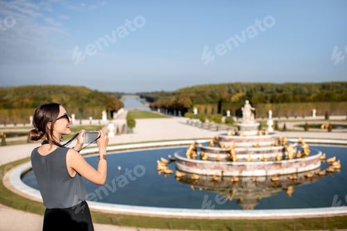 Preview: Woman tourist visiting Versailles gardens