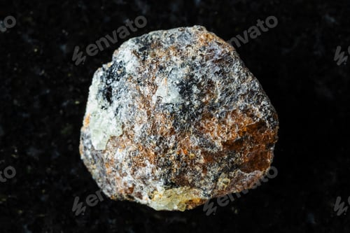 Preview: sample of raw brown titanite mineral on black