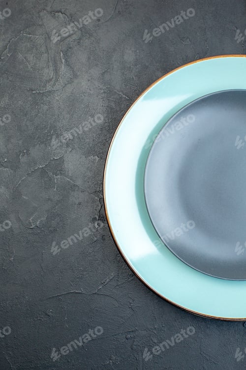 Preview: top view blue plate with gray plate on dark background silverware diner colourful femininity hunger