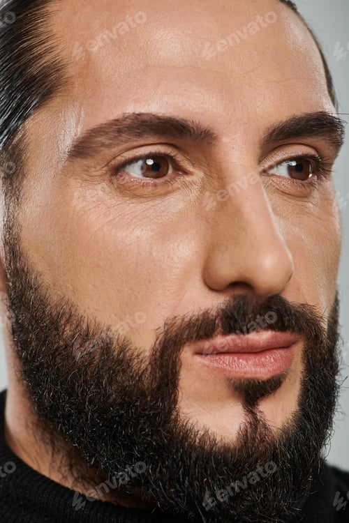 Preview: close up shot of confident bearded arabic man in black turtleneck posing on grey background
