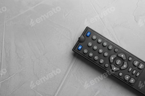 Preview: Modern tv remote control on grey table, top view. Space for text