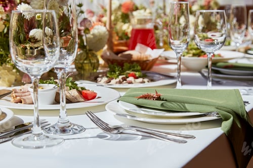 Preview: Table setting in elegant chamber is graced by candles and flowers arrangement