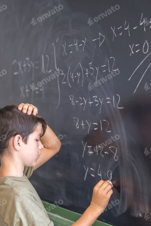 Preview: Schoolboy solving a problem on a blackboard.