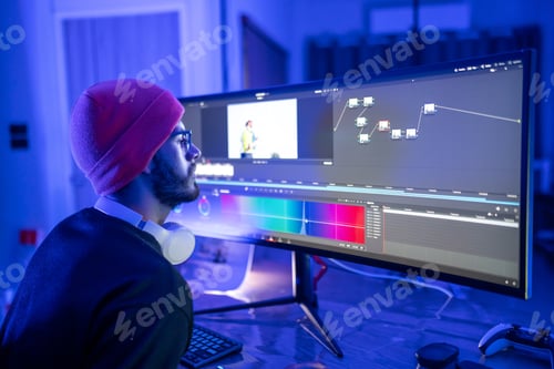 Preview: Editor working with computer at home with RGB ambient light.