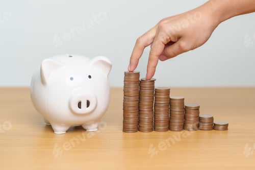 Preview: Hand near Stacks of Coins and Piggy Bank