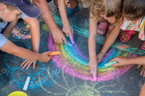 Preview: Children paint a rainbow on the asphalt. Selective focus.