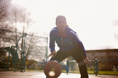 Preview: Mature woman playing basketball in park