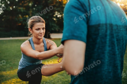 Preview: Fitness woman exercising with help of coach