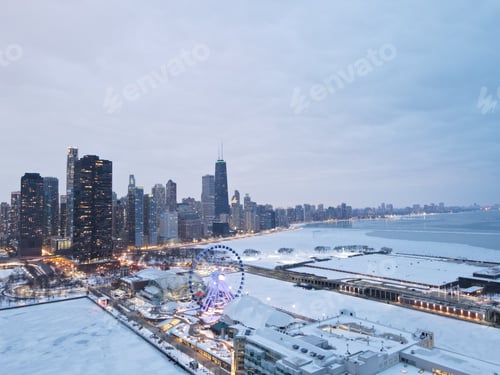 Preview: Majestic view of Chicago with a ferris wheel in the foreground and snow-capped buildings