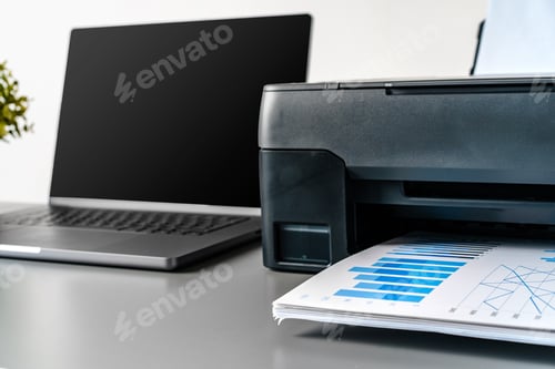 Preview: Printer and laptop on grey table in office