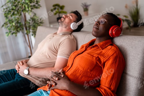 Preview: Relaxing moment for two people enjoying music at home in a cozy living room space