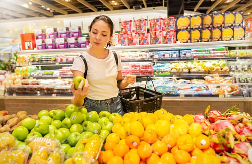 Preview: Portrait of caucasian woman looking at product at grocery store
