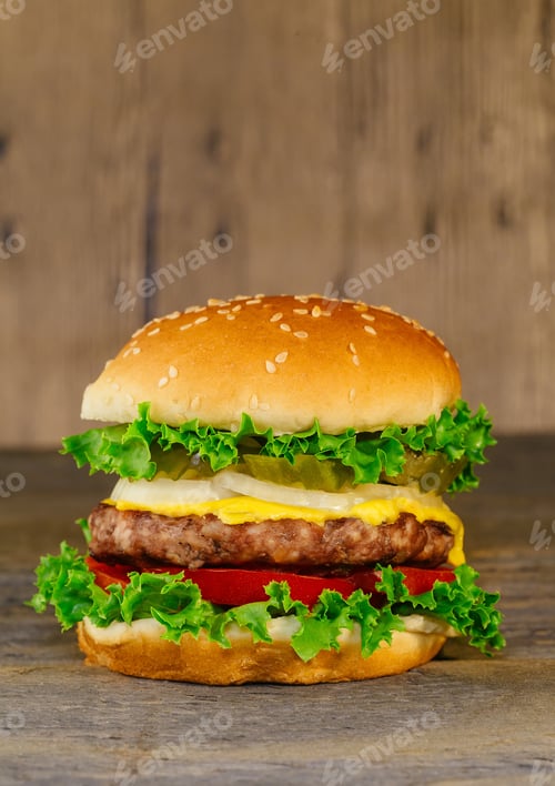 Preview: Classic deluxe cheeseburger with lettuce, onions, tomato and pickles on a sesame seed bun