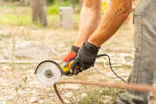 Preview: Hands of a man using a radial saw