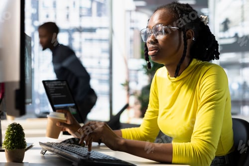 Preview: Office clerk looking at computer monitor, checking key data