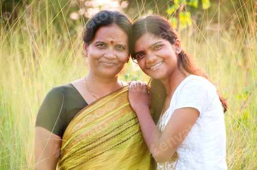 Preview: Portrait of happy mother and daughter in meadow at sunset. Smart Blurred photo